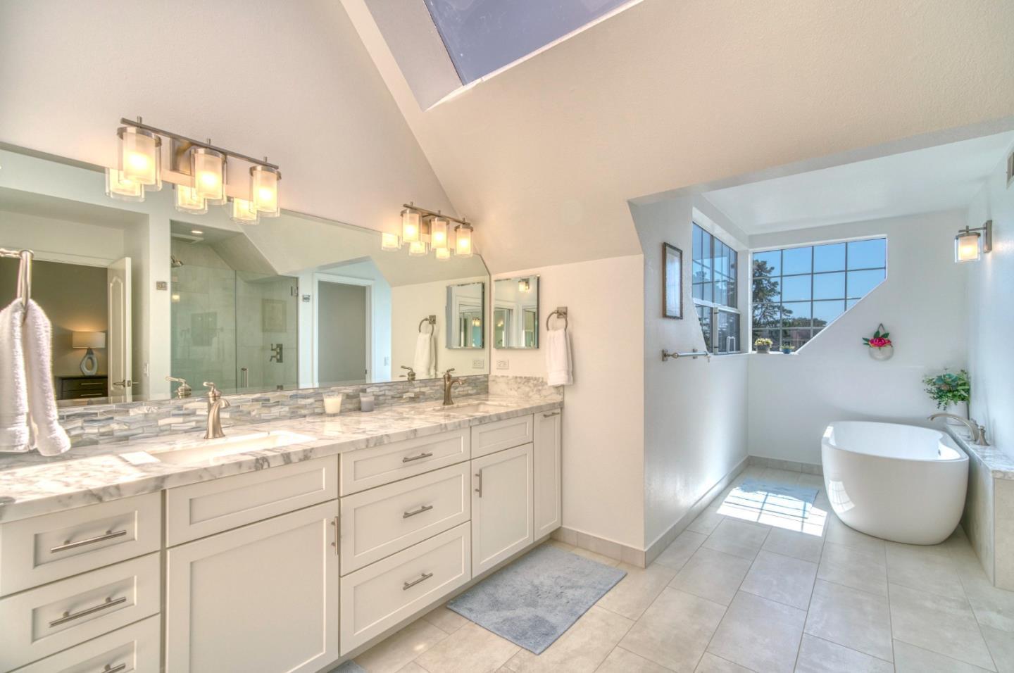 21 Merion Road Half Moon Bay, CA 94019 - Photo 21 of 35 a spacious bathroom with a granite countertop sink and a mirror