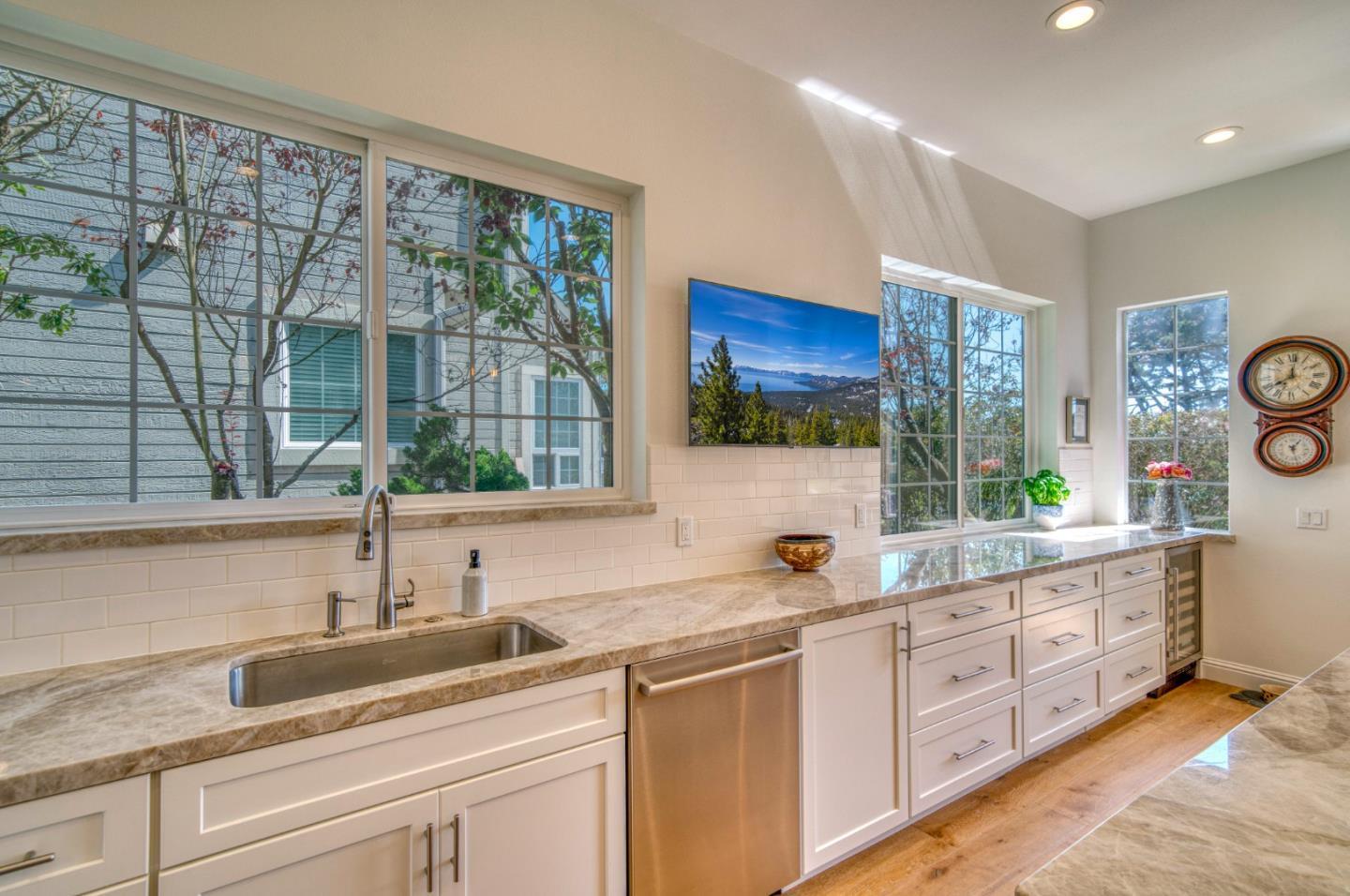 21 Merion Road Half Moon Bay, CA 94019 - Photo 10 of 35 a kitchen with stainless steel appliances wooden cabinets a sink and a large window