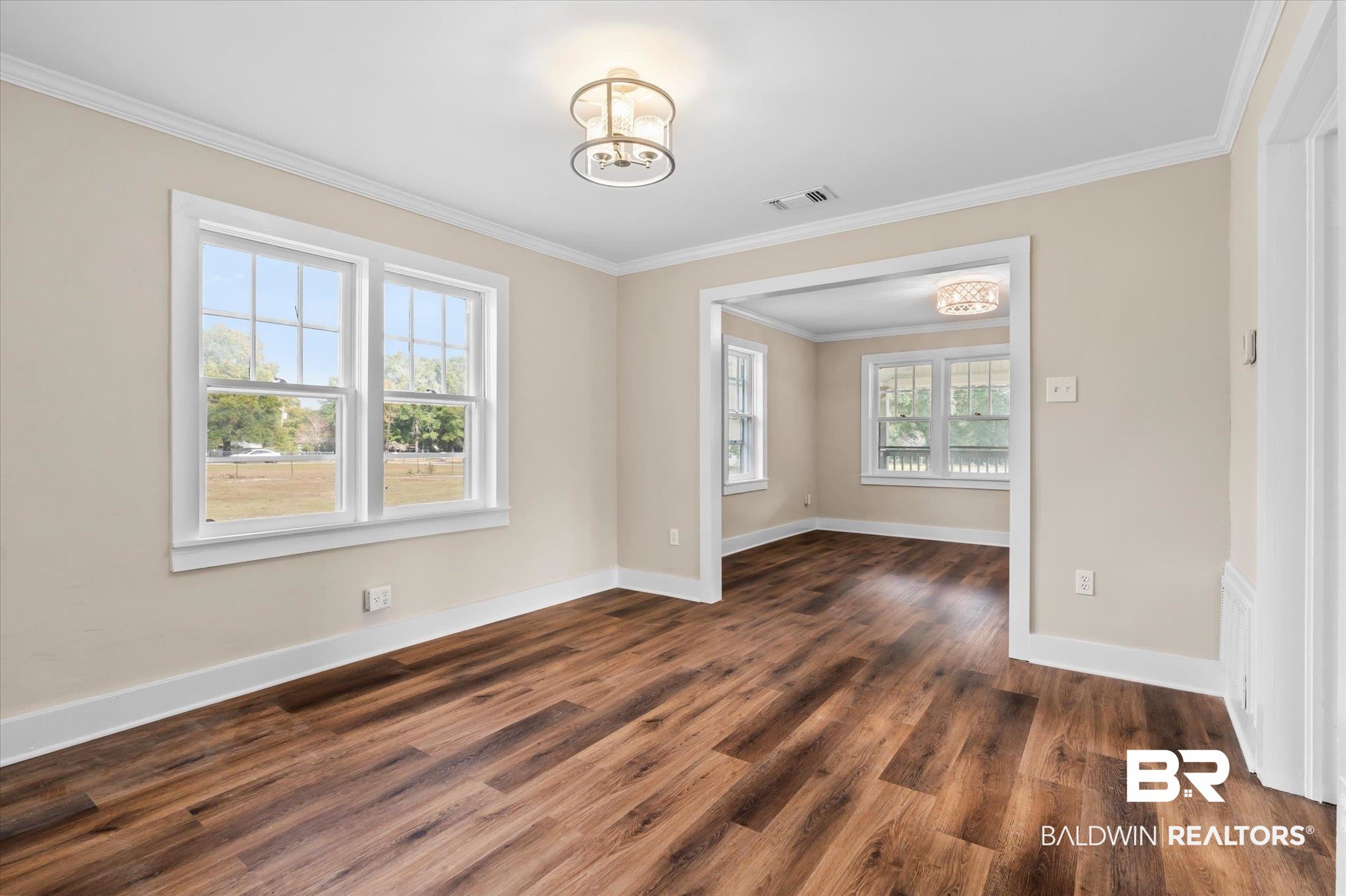 4630 General Road Mobile, AL 36619 - Photo 8 of 33 Unfurnished room with dark wood-type flooring, a chandelier, and ornamental molding