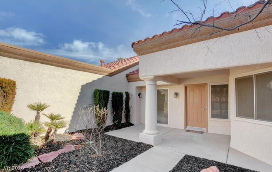 2716 Showcase Drive Las Vegas, NV 89134 - Photo 5 of 45 A graceful entry with terracotta roof accents and desert-friendly landscaping welcomes you.