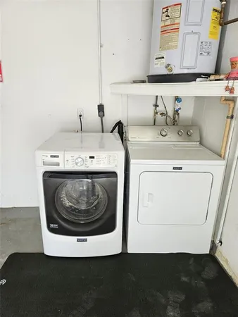 a utility room with a sink washer and dryer
