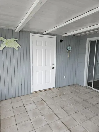 a view of a room with an empty space and a window