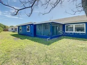 a view of a house with a backyard