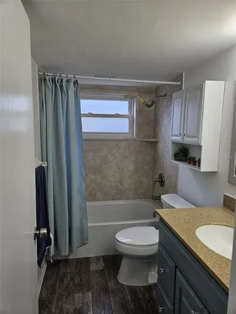a bathroom with a toilet a sink and bathtub