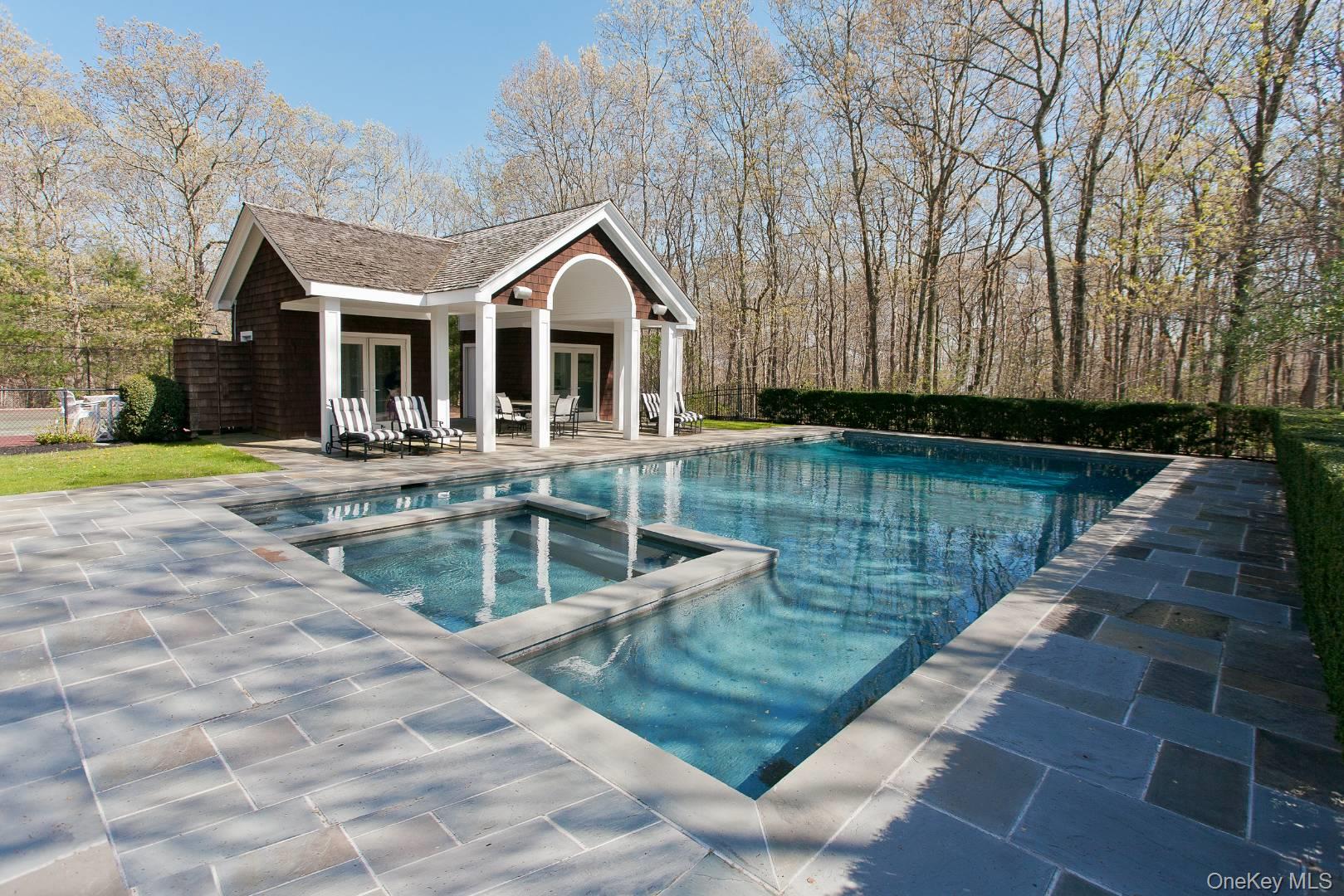 1477 Deerfield Road Water Mill, NY 11976 - Photo 4 of 17 View of pool featuring a storage structure, an outdoor structure, a patio area, and a pool with connected hot tub