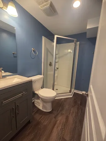 a bathroom with a toilet a sink and shower