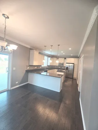 a large kitchen with a lot of counter space and stainless steel appliances