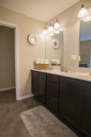 a bathroom with a double vanity sink and a mirror