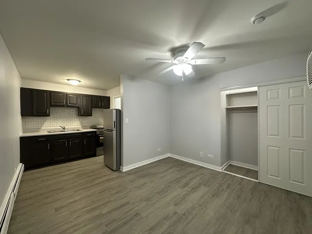 a kitchen with a refrigerator and a stove top oven