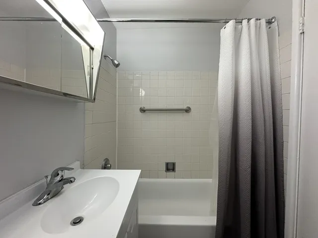 a bathroom with a tub and a sink