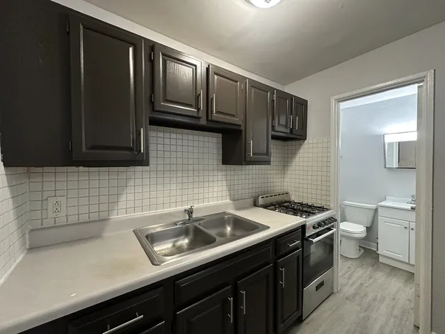 a kitchen with a sink and cabinets