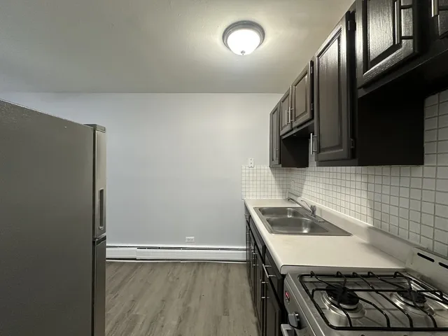 a kitchen with stainless steel appliances a stove a sink and a microwave