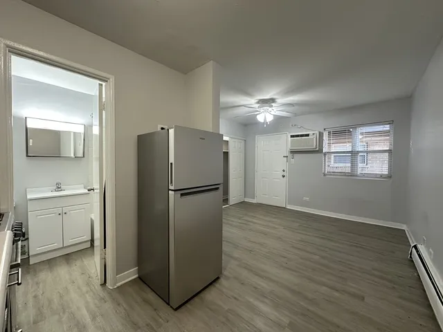 a view of a kitchen with a white cabinet and a stove top oven