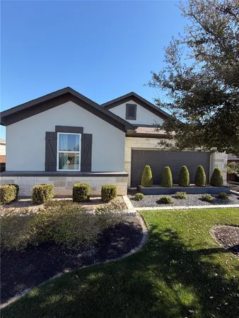 a front view of house with yard and outdoor seating