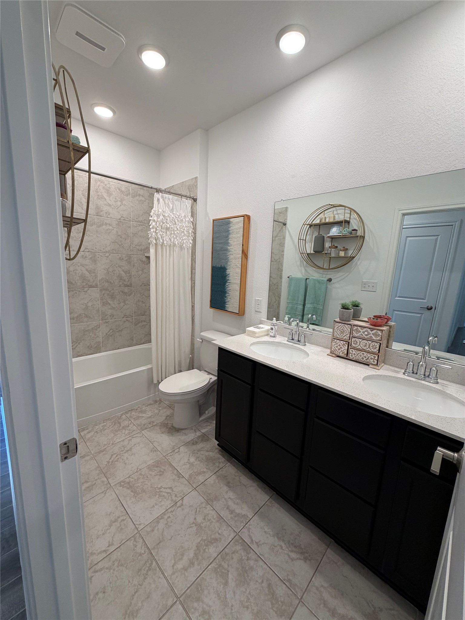 306 Stinchcomb Road Hutto, TX 78634 - Photo 13 of 19 a bathroom with a double vanity sink mirror double shower and a toilet