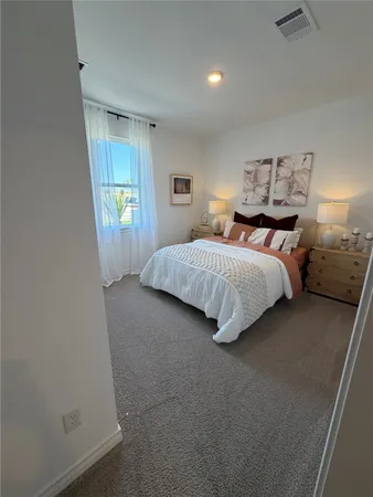 a bedroom with a bed and window