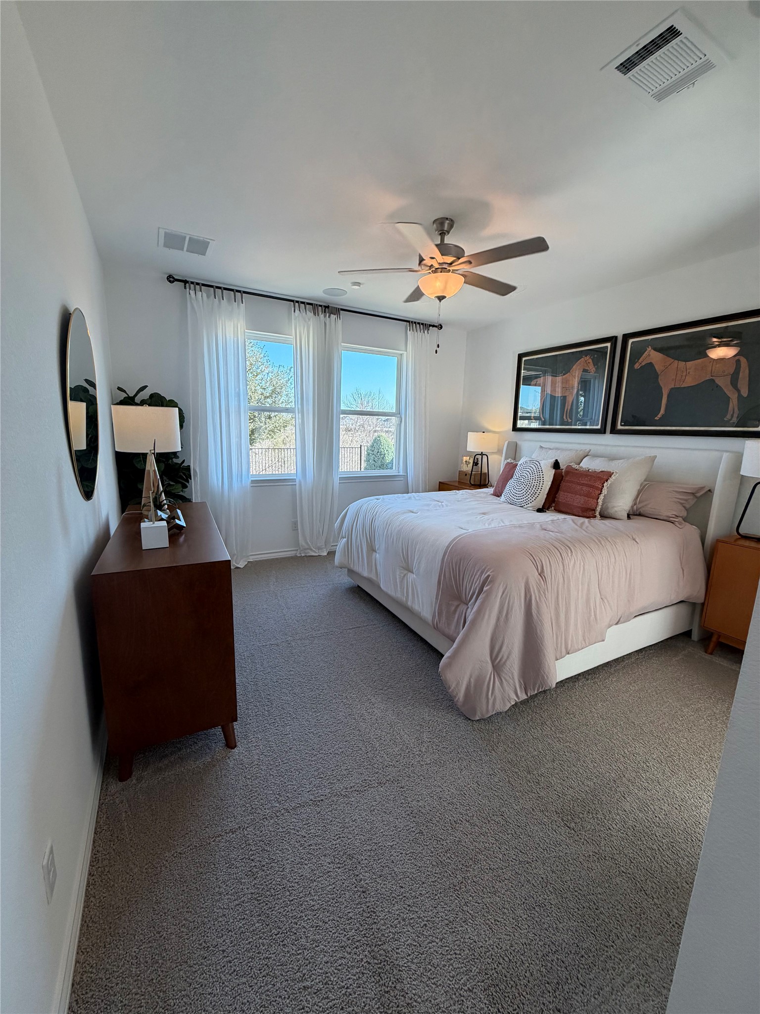 306 Stinchcomb Road Hutto, TX 78634 - Photo 7 of 19 a bedroom with a bed and a chandelier