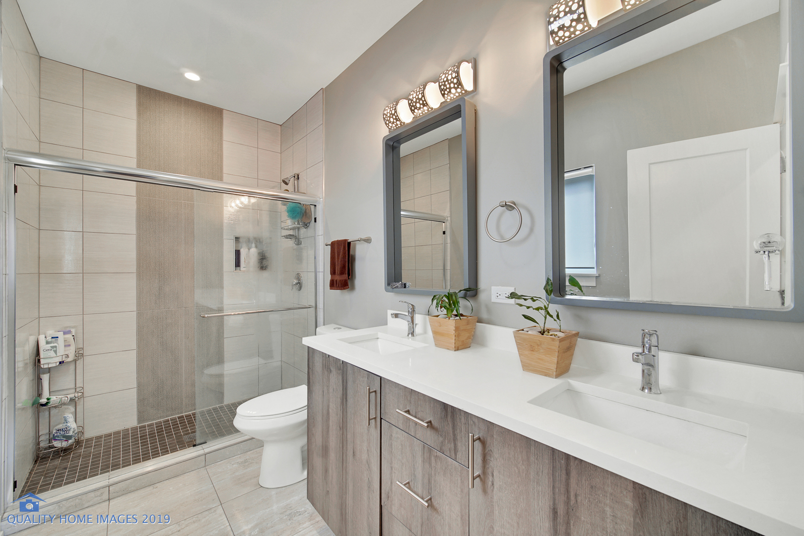 Undisclosed Address Chicago, IL 60608 - Photo 4 of 11 a bathroom with a double vanity sink toilet and shower