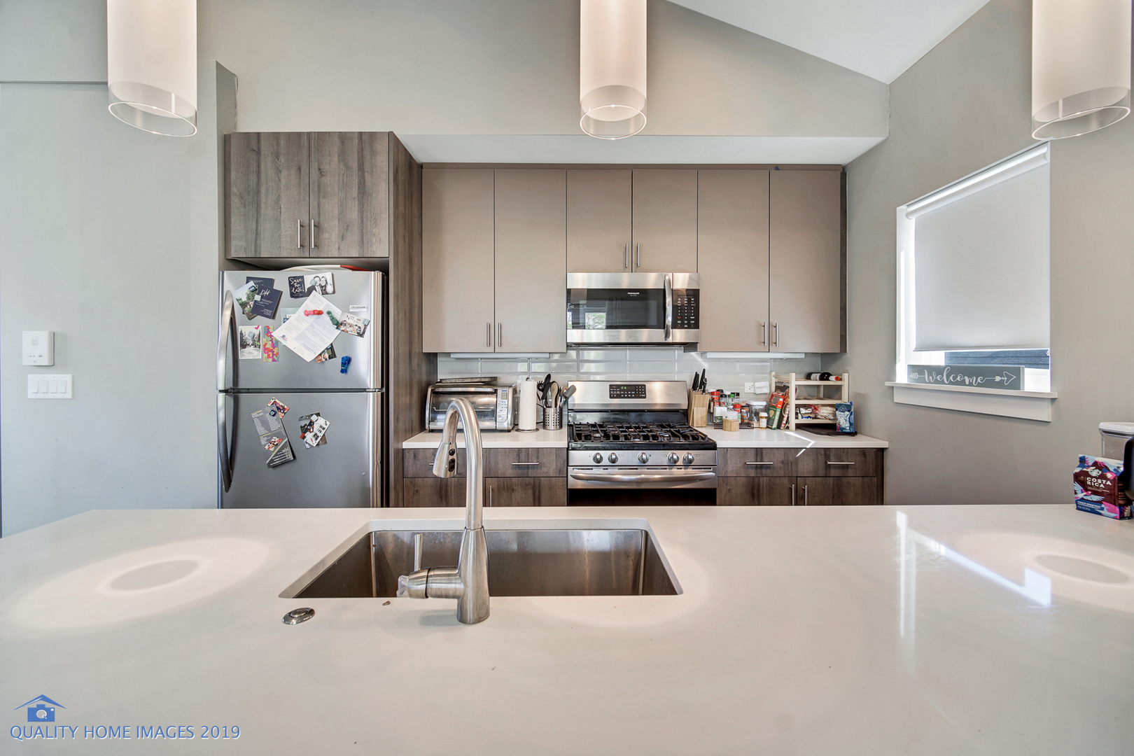 Undisclosed Address Chicago, IL 60608 - Photo 8 of 11 a kitchen with kitchen island a stove a sink and a refrigerator