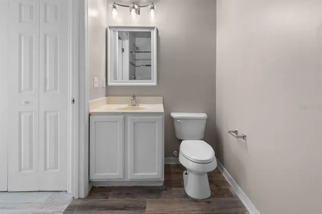 a bathroom with a toilet a sink and mirror