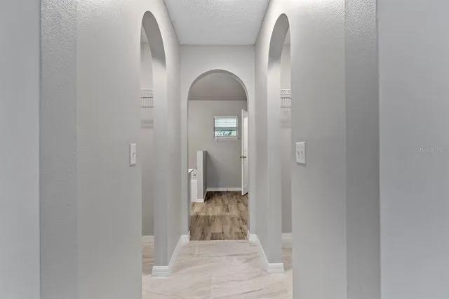 a view of a bathroom with mirror and shower
