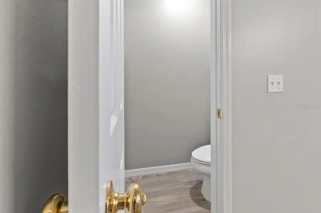 a bathroom with a granite countertop toilet and a sink