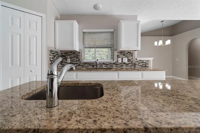 a bathroom with a sink a mirror and shower