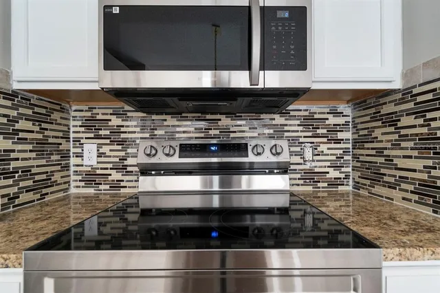 a stove top oven sitting inside of a kitchen