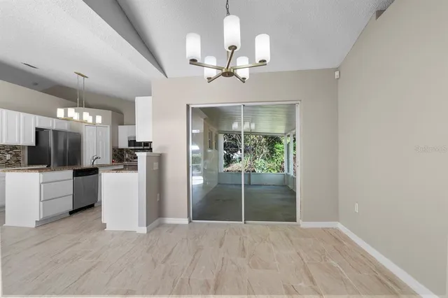 a view of a kitchen with a sink and refrigerator