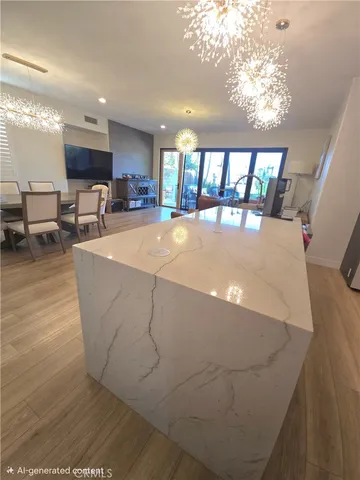 a living room with furniture a table and kitchen view