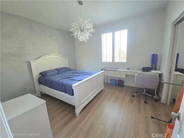a spacious bedroom with a bed and a table chair