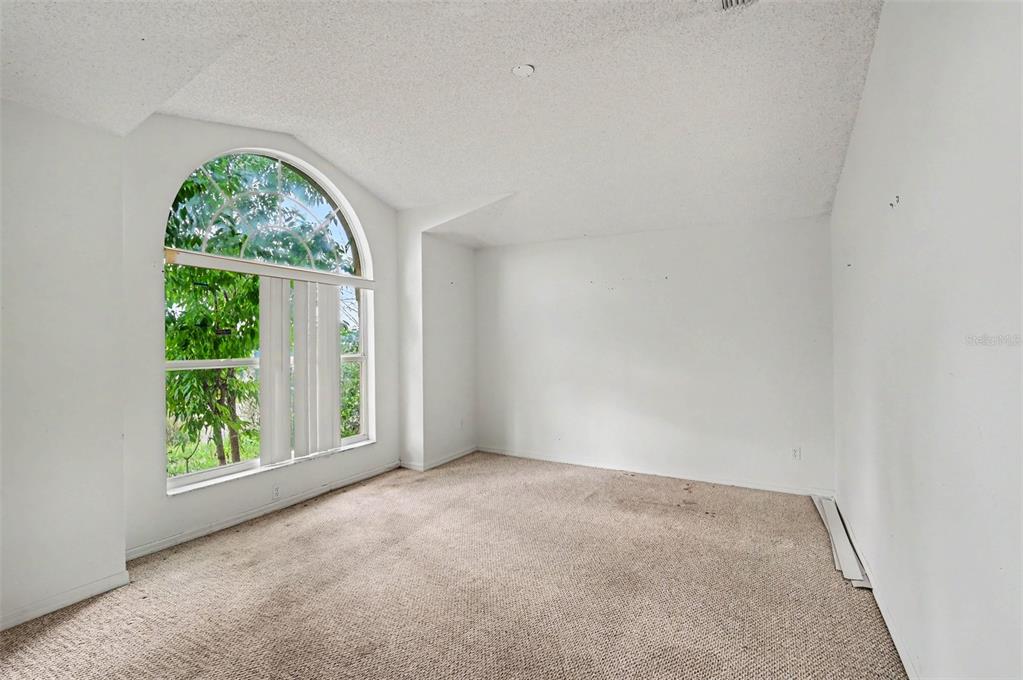 4716 Spaniel Street Orlando, FL 32818 - Photo 11 of 27 an empty room with windows