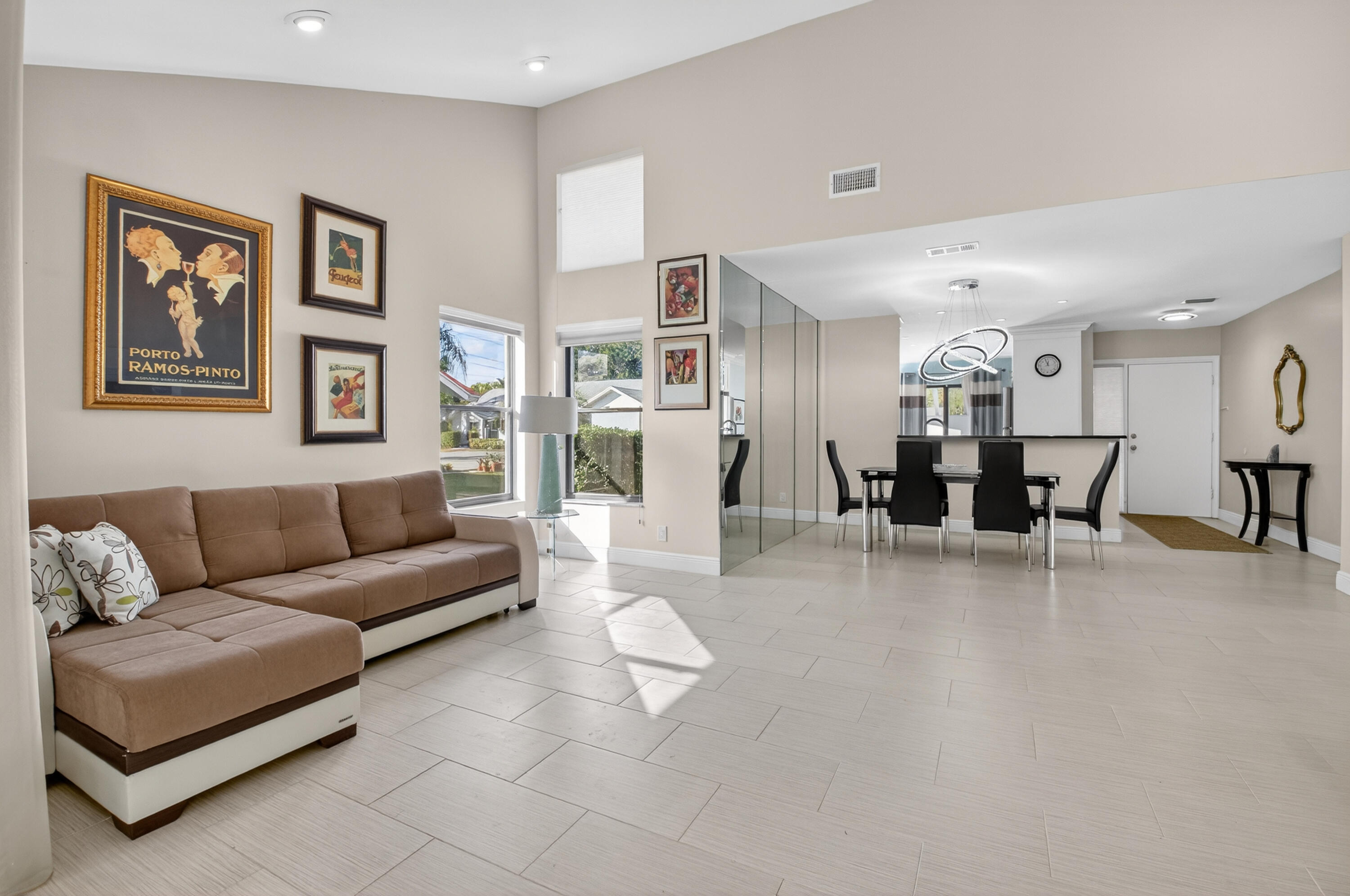 10980 Hidden Lake Place Boca Raton, FL 33498 - Photo 12 of 47 a living room with furniture and a dining table with kitchen view