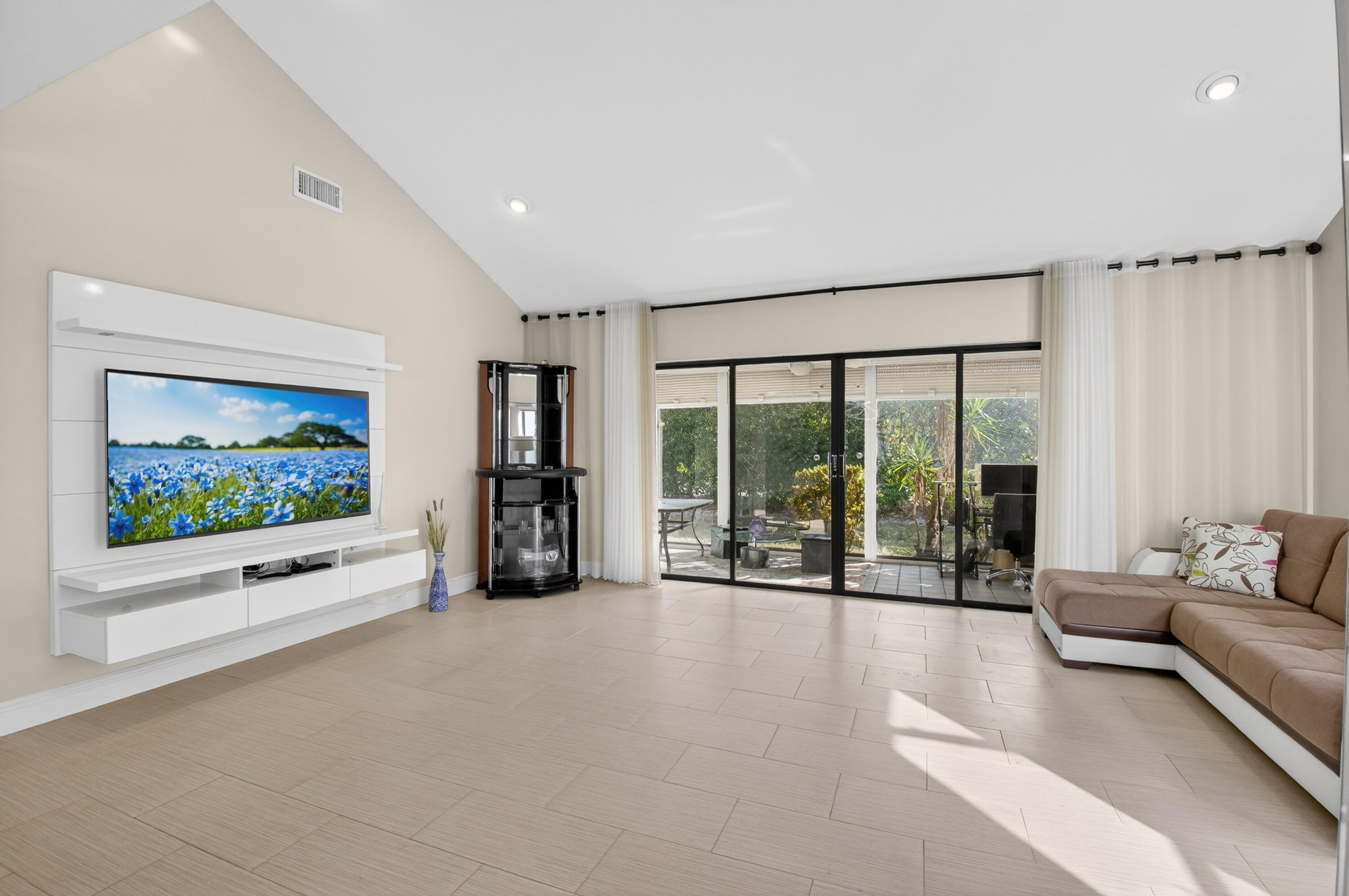 10980 Hidden Lake Place Boca Raton, FL 33498 - Photo 13 of 47 a living room with furniture large window and flat screen tv