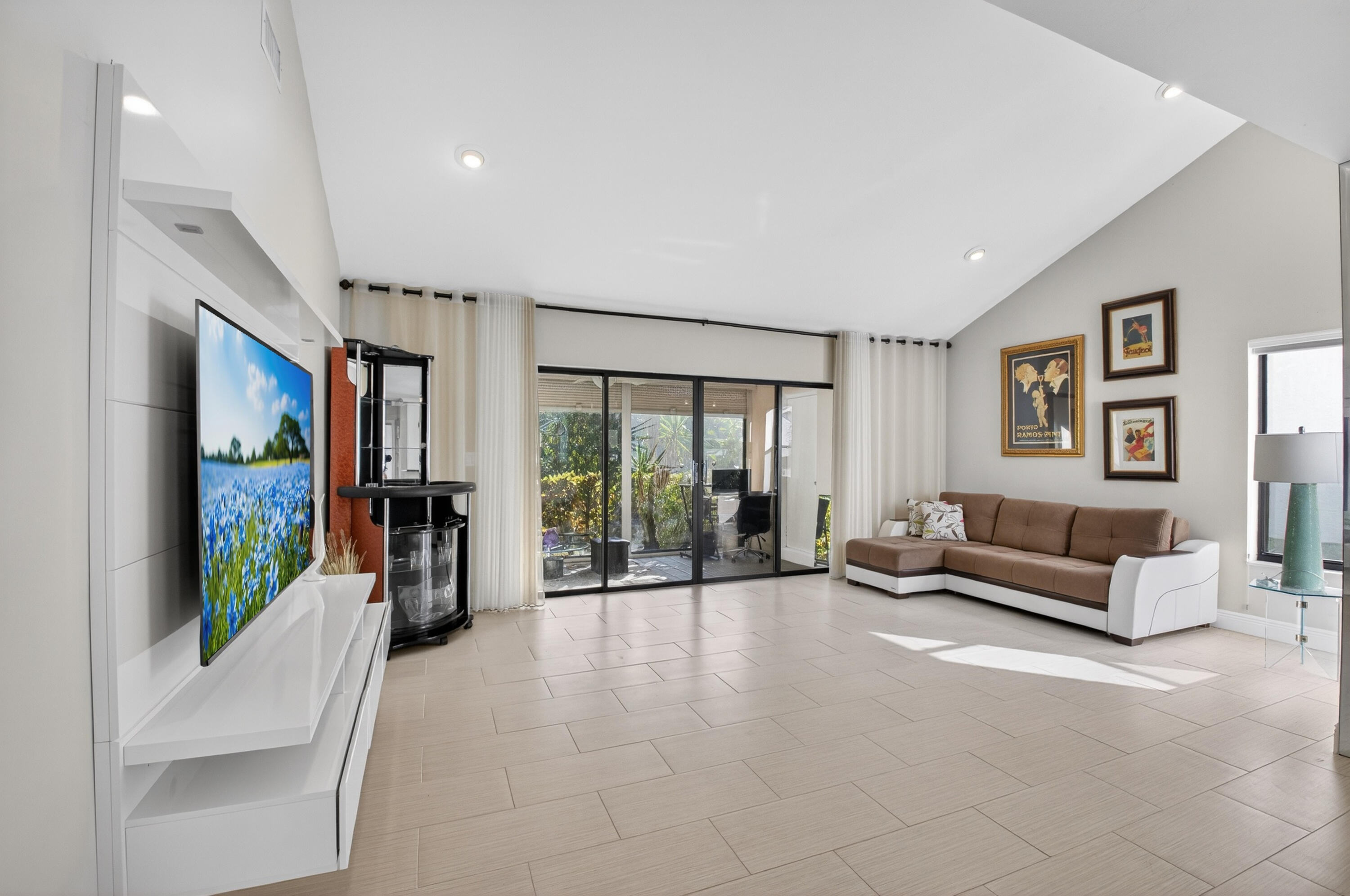 10980 Hidden Lake Place Boca Raton, FL 33498 - Photo 15 of 47 a living room with furniture large window and flat screen tv