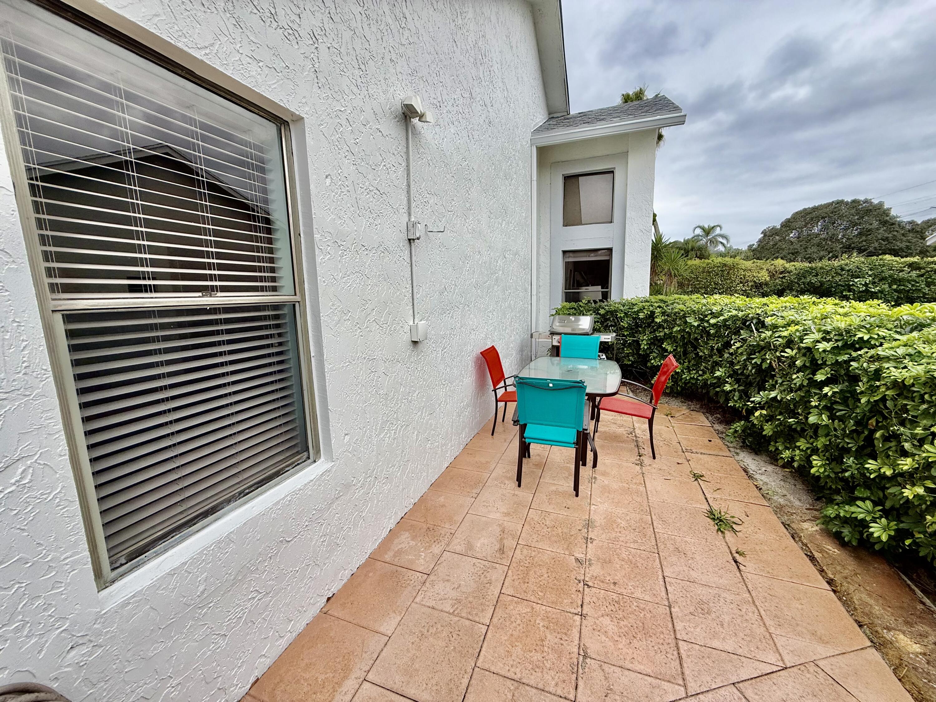 10980 Hidden Lake Place Boca Raton, FL 33498 - Photo 27 of 47 a balcony with furniture and flowers