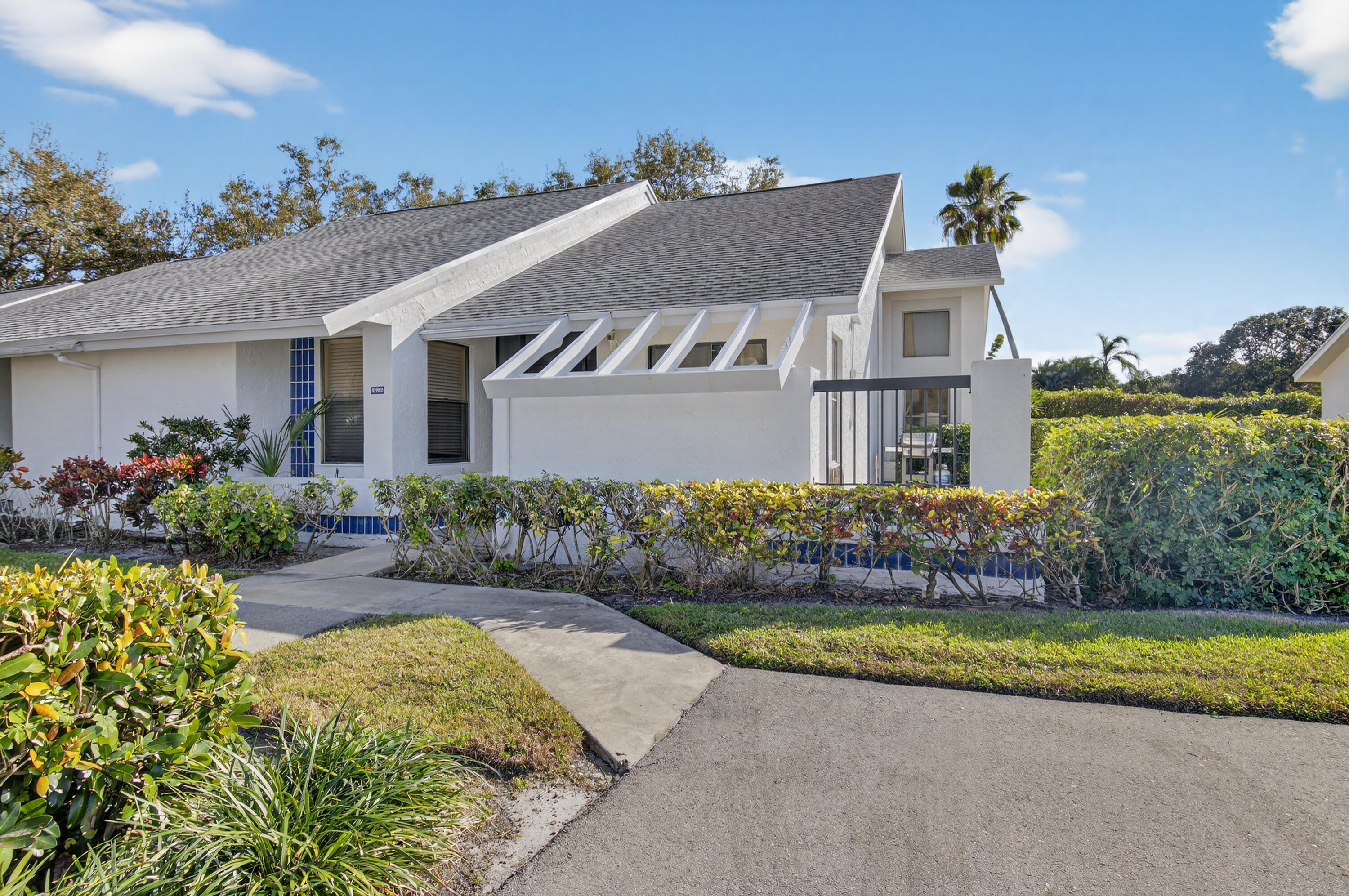 10980 Hidden Lake Place Boca Raton, FL 33498 - Photo 3 of 47 front view of house with a yard