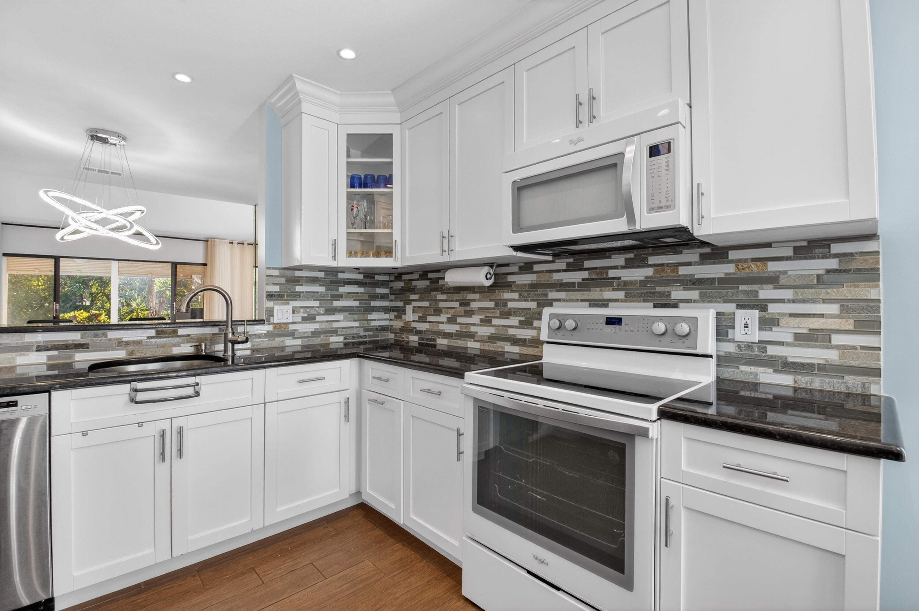 10980 Hidden Lake Place Boca Raton, FL 33498 - Photo 4 of 47 a kitchen with granite countertop white cabinets stainless steel appliances and sink