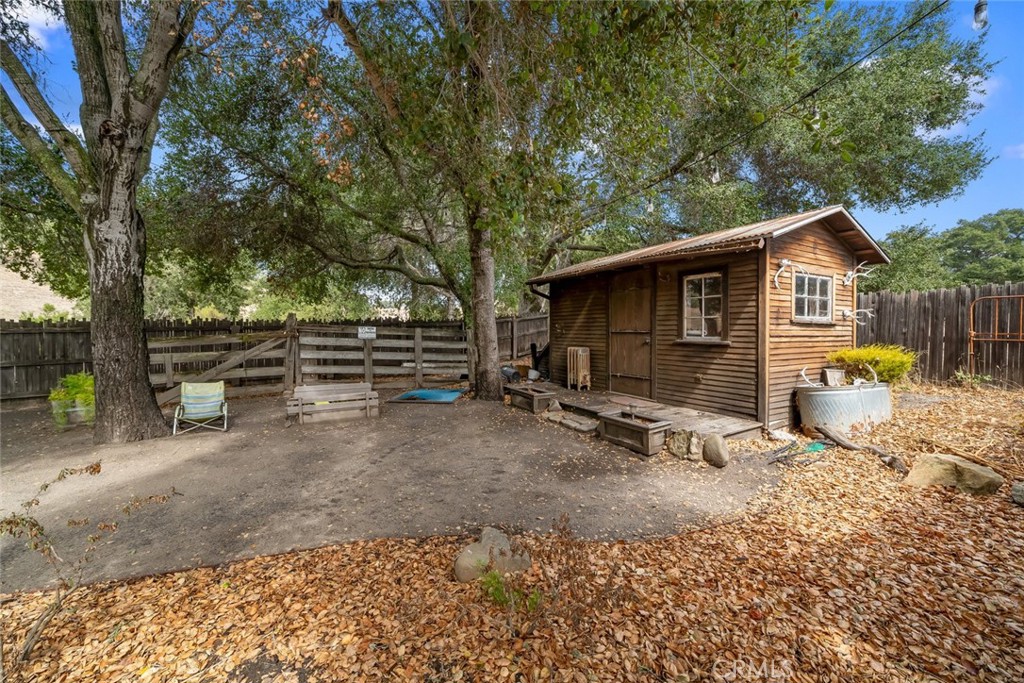 10330 Huasna Road Arroyo Grande, CA 93420 - Photo 20 of 74 a view of backyard with wooden fence and a large tree
