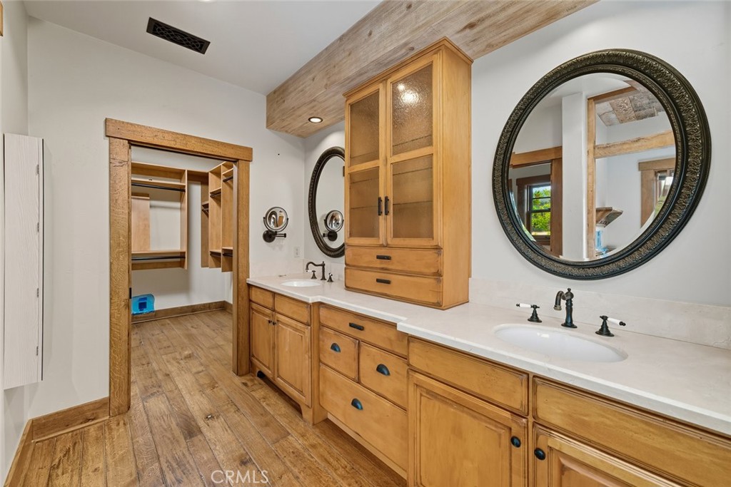 10330 Huasna Road Arroyo Grande, CA 93420 - Photo 25 of 74 a bathroom with a double vanity sink and a mirror