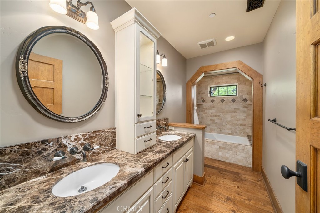 10330 Huasna Road Arroyo Grande, CA 93420 - Photo 32 of 74 a bathroom with a granite countertop sink mirror and vanity