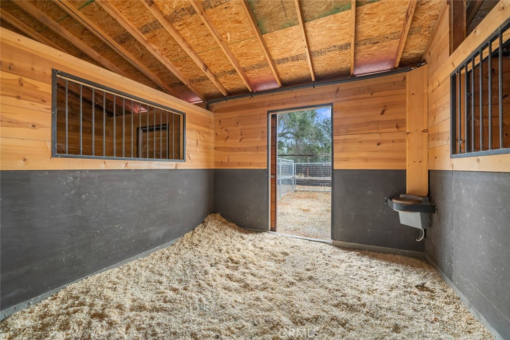 10330 Huasna Road Arroyo Grande, CA 93420 - Photo 58 of 74 a bedroom with a bed and wooden floor