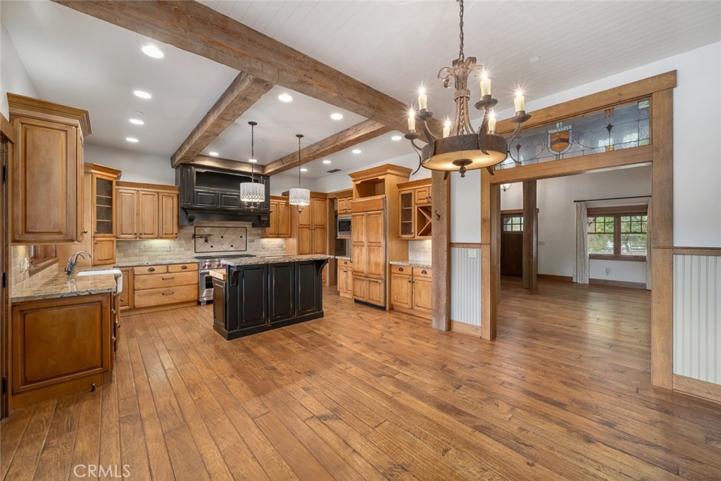 10330 Huasna Road Arroyo Grande, CA 93420 - Photo 9 of 74 a large kitchen with stainless steel appliances granite countertop a lot of counter space and wooden floors