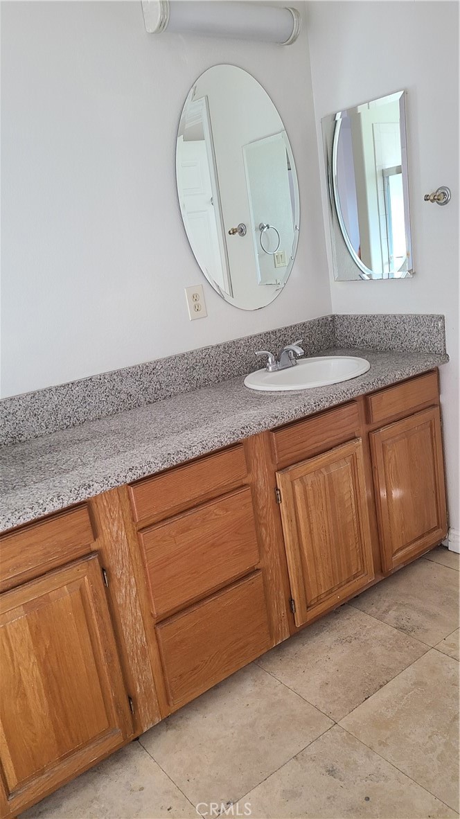 319 Lampman Way Placentia, CA 92870 - Photo 12 of 19 a bathroom with a sink a mirror and a vanity