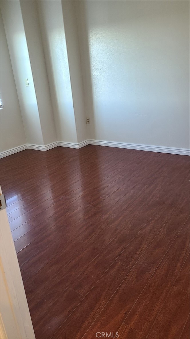319 Lampman Way Placentia, CA 92870 - Photo 13 of 19 an empty room with wooden floor and windows
