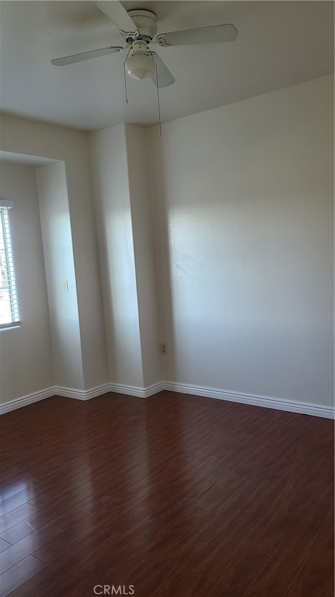 319 Lampman Way Placentia, CA 92870 - Photo 14 of 19 an empty room with wooden floor and windows