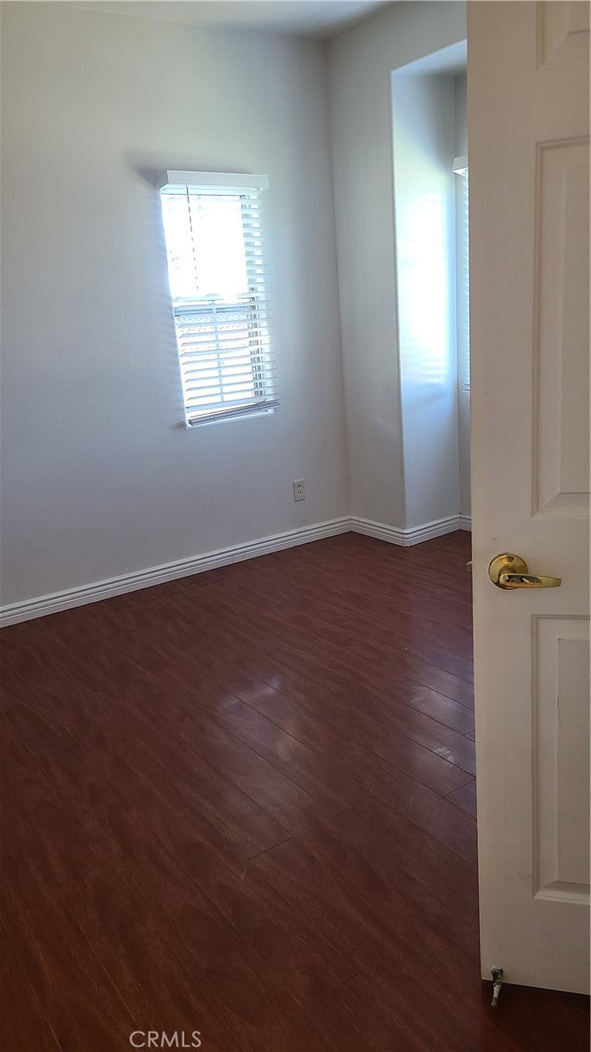319 Lampman Way Placentia, CA 92870 - Photo 17 of 19 an empty room with wooden floor and windows