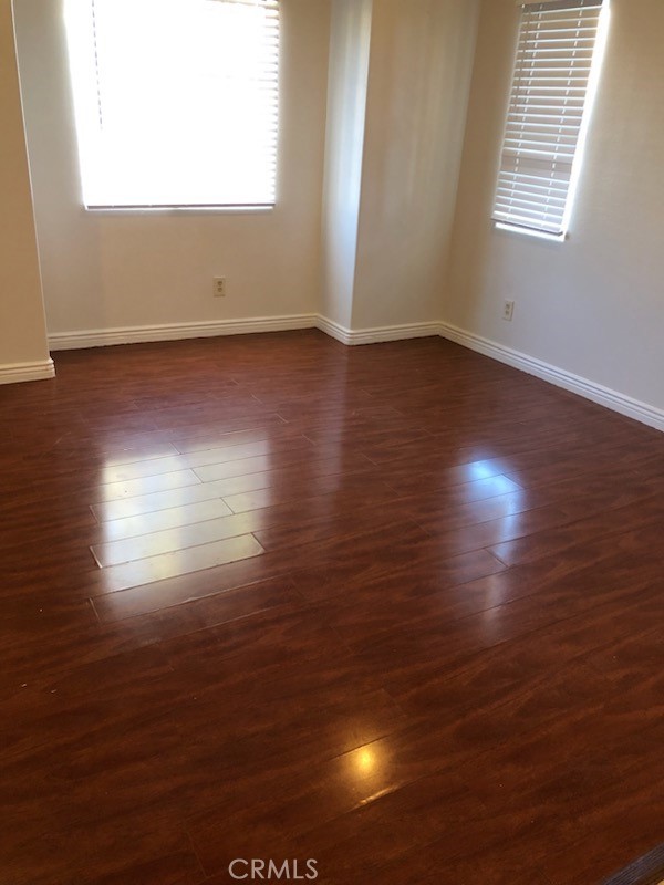319 Lampman Way Placentia, CA 92870 - Photo 3 of 19 an empty room with wooden floor and windows