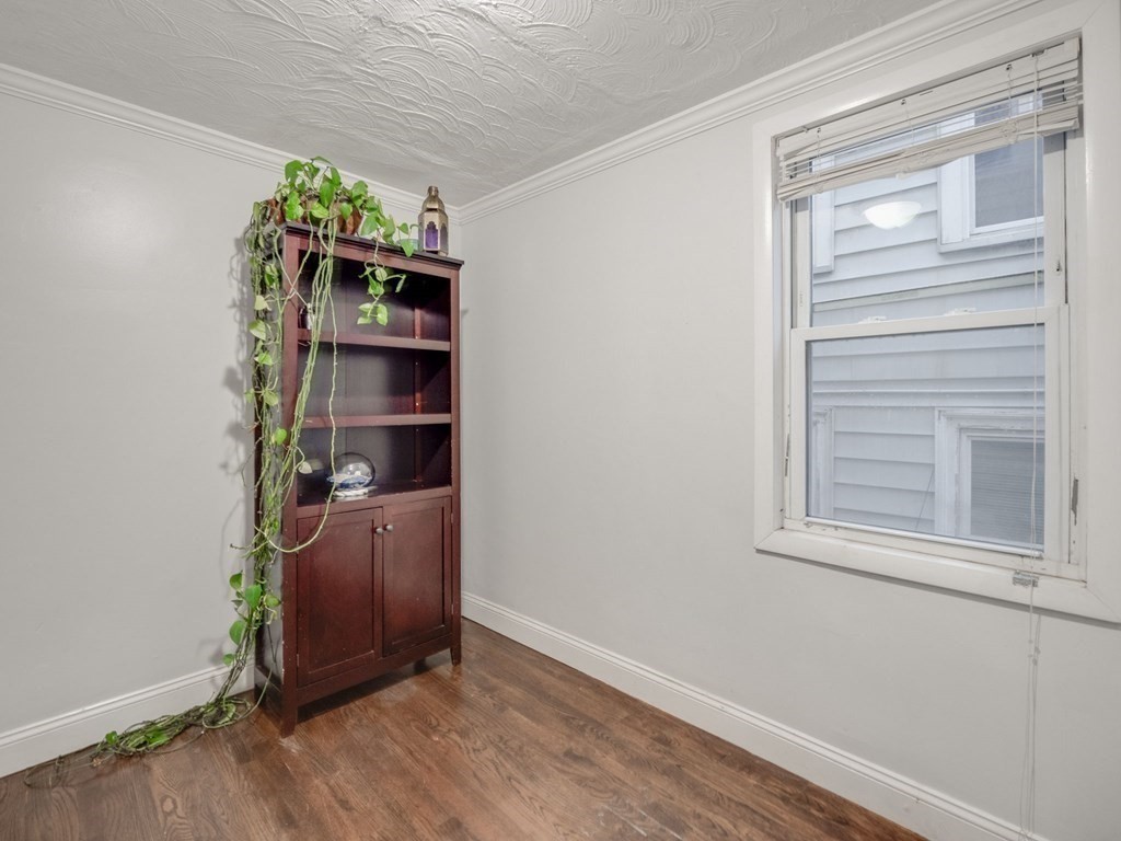 48 Chestnut Street Chelsea, MA 02150 - Photo 12 of 42 a room with bookshelf and wooden floor