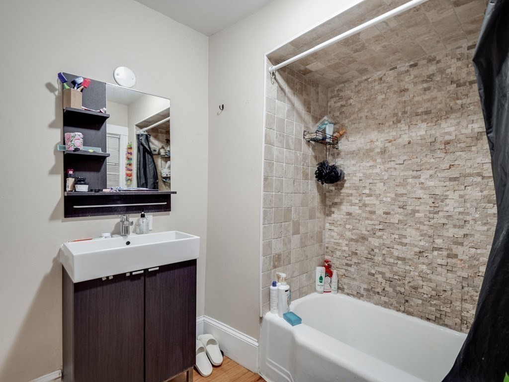 48 Chestnut Street Chelsea, MA 02150 - Photo 16 of 42 a bathroom with a sink and a mirror